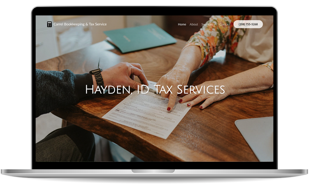 tax-prep-mockup-01 A laptop screen displays a website for Hayden, ID Tax Services, showing two people reviewing a document at a wooden desk.